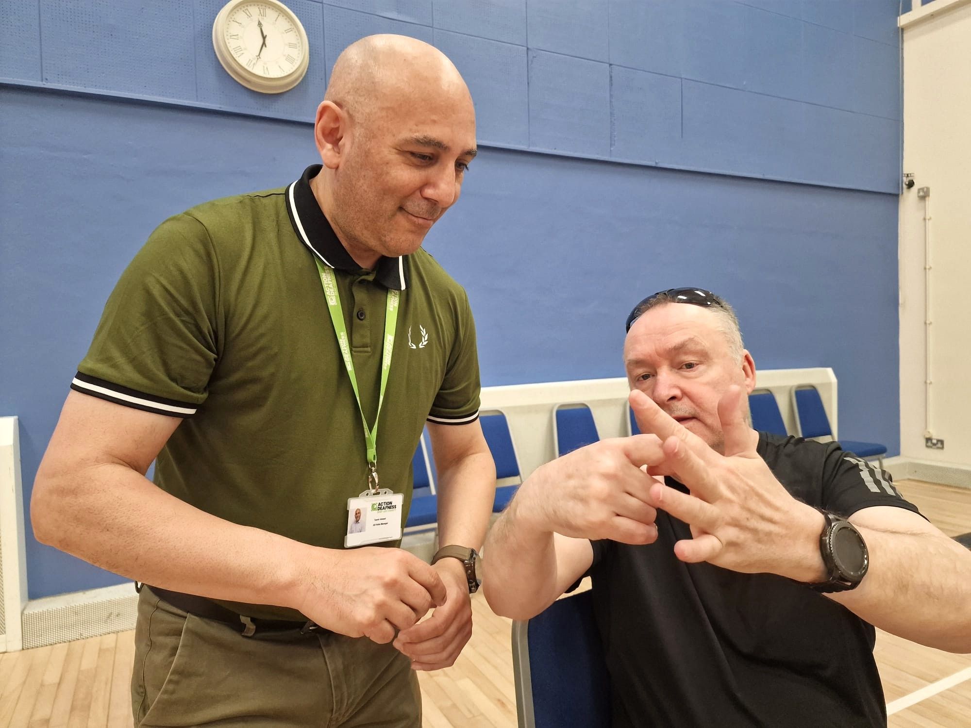 Photo of AD staff and person signing