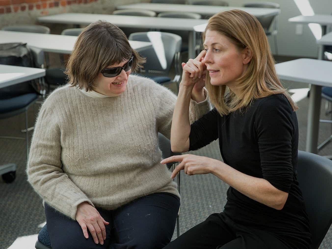Deafblind person with a person signing