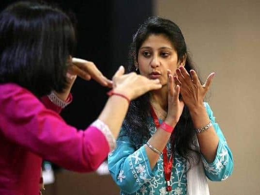 Two people signing to each other