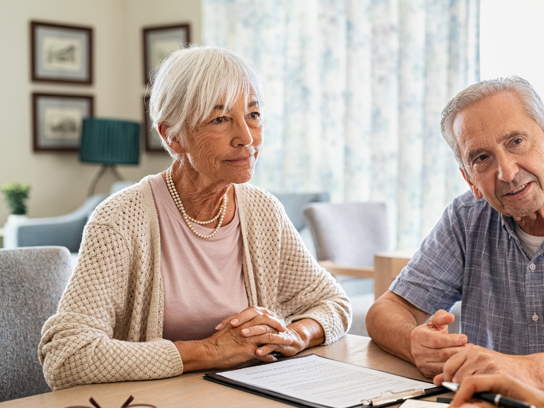 Two people having discussions with staff
