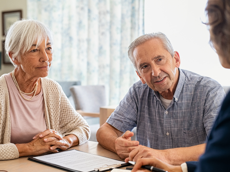 Two people having discussions with staff