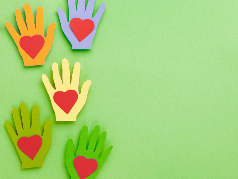 Support us green background with handprints made from paper