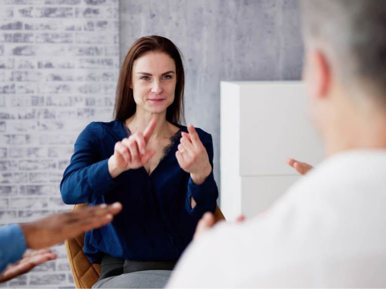 Image of person interpreting to another person in sign language